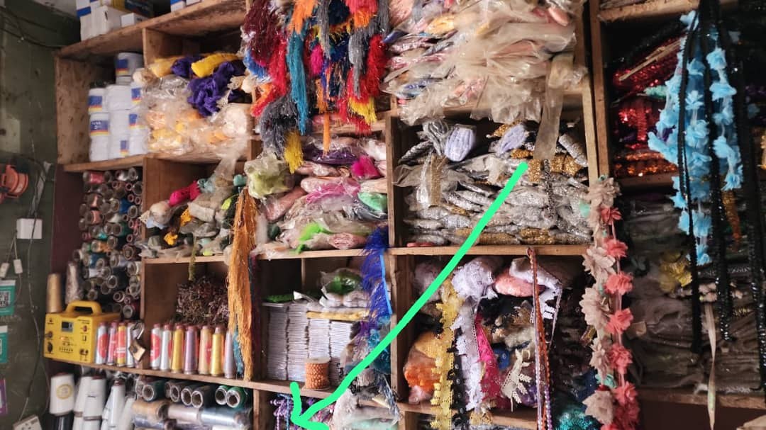 Shelving in the Bosere Textile shop holding packaged sewing accessories, threads, ribbons and trimmings.